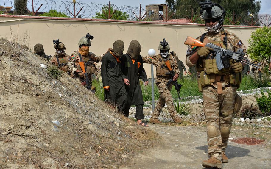 National Directorate of Security forces escort alleged Taliban fighters before they are presented to the media following an operation in Nangarhar province, Afghanistan, in Jalalabad on March 14, 2021.