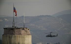 FILE - A Russian helicopter flies over the Hmeimim Air Base, a Syrian airbase currently operated by Russia, located southeast of the city of Latakia in the town of Hmeimim, Syria, on Monday, Dec.16, 2024. (AP Photo/Leo Correa, File)