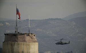 FILE - A Russian helicopter flies over the Hmeimim Air Base, a Syrian airbase currently operated by Russia, located southeast of the city of Latakia in the town of Hmeimim, Syria, on Monday, Dec.16, 2024. (AP Photo/Leo Correa, File)