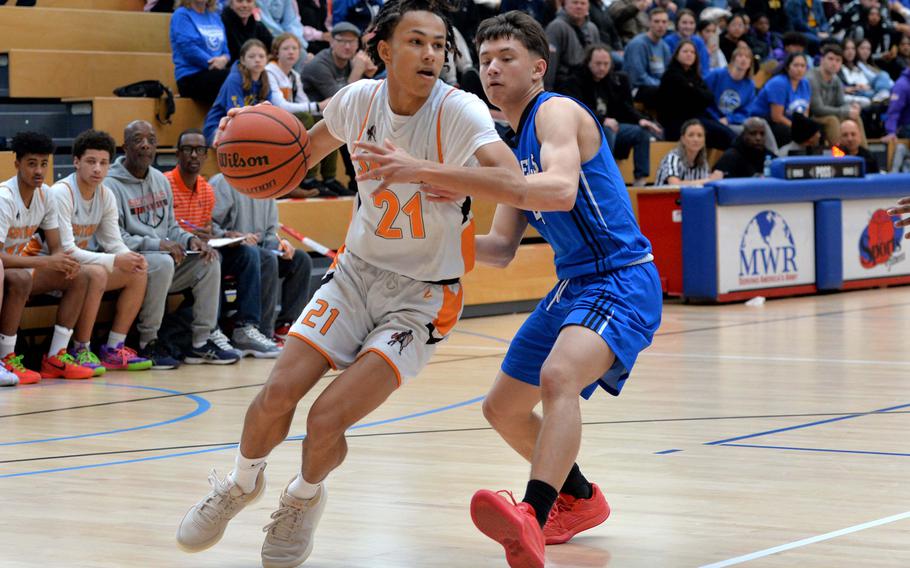 Spangdahlem’s Cameron Lewis drives against Theo Reyes of Hohenfels in the boys Division III final at the DODEA-Europe basketball championships in Wiesbaden, Germany, Feb. 17, 2024. Spangdahlem won the the game 65-63.