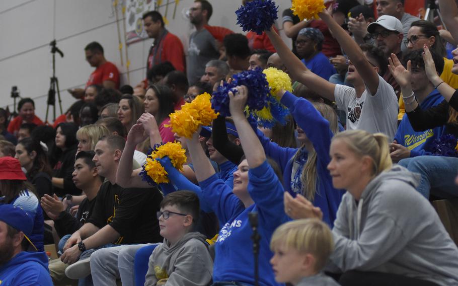 Fans wearing blue and gold cheer for Wiesbaden during the DODEA-Europe Division I girls’ volleyball championship on Saturday, Oct. 29, 2022, at Ramstein High School in Germany. Wiesbaden won the match in four sets.