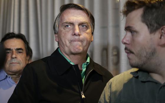 Brazil's former President Jair Bolsonaro prepares to speak to the press in Belo Horizonte, Brazil, June 30, 2023, the day that judges ruled him ineligible to run for any political office again until 2030 after concluding that he abused his power and cast unfounded doubts on the country's electronic voting system.  According to a Federal Police indictment unveiled Tuesday, March 19, 2024, Bolsonaro turned to an aide-de-camp and asked him to insert false data into the public health system to make it appear as though he and his daughter had received the COVID-19 vaccine, in order to have the necessary vaccination certificate required by U.S. authorities for their 2023 trip to Florida.