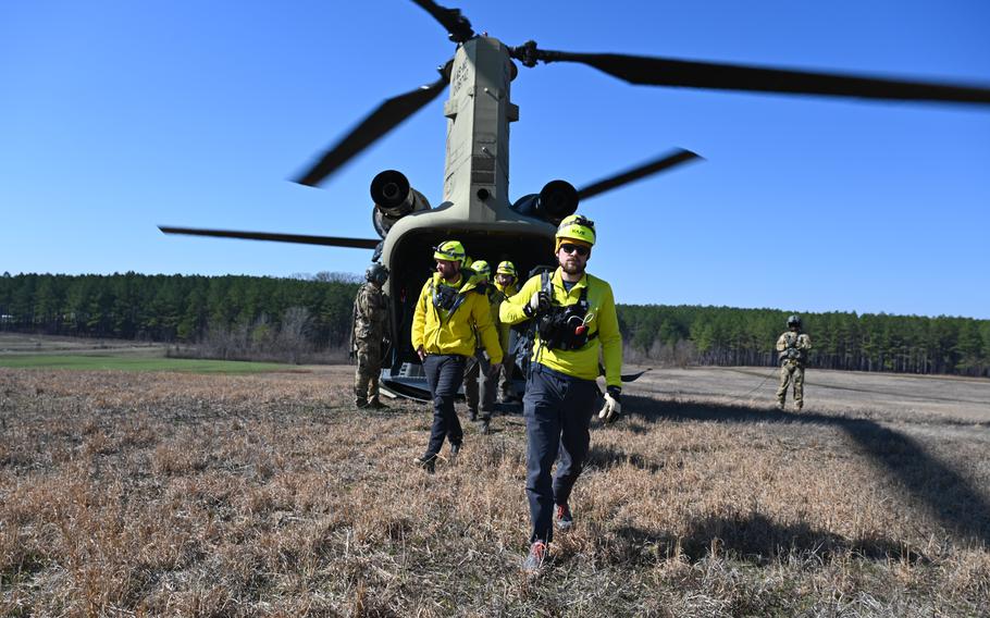 Team BUSAR (Backcountry Unit Search and Rescue), a search and rescue organization based in the Great Smoky Mountains, and Air National Guard Security Forces work together to conduct search and rescue operations during PATRIOT 24 exercise at Camp McCain, Grenada, Miss., Tuesday, Feb. 20, 2024.