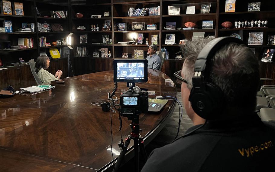 "Brat Ambition" director Kimberly McKay, left, interviews former NFL safety George Teague at the Dallas Cowboys practice facility in Frisco, Texas, in February 2023. Brad Heath, the film's producer, operates the camera.