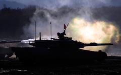 Japanese Ground-Self Defense Force (JGDDF) Type 90 tanks fire their guns at a target during the annual drill with live ammunitions exercise at Minami Eniwa Camp in Eniwa, northern Japan island of Hokkaido on Dec. 6, 2021. 