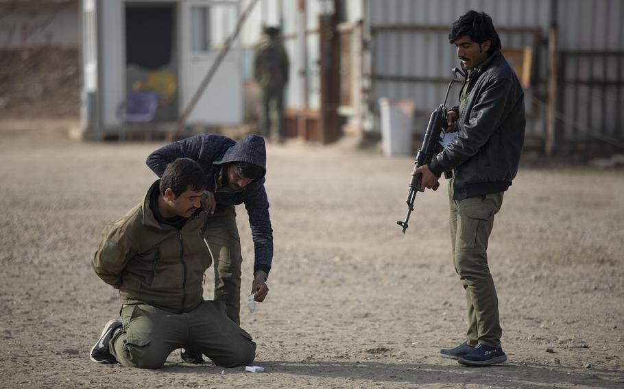 Syrian students at Asayish training academy demonstrate a suspect search during an exercise in the al-Hasakah region of Syria on Dec. 22, 2022. The U.S. military recently reported a lack of progress in certain efforts to train security forces in Iraq and Syria to fight the Islamic State.