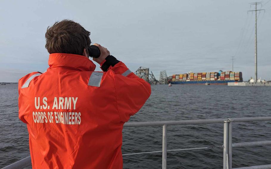 U.S. Army Corps of Engineers Navigation staff observe the damage resulting from the collapse of the Francis Scott Key Bridge in Baltimore, Tuesday, March 26, 2024.