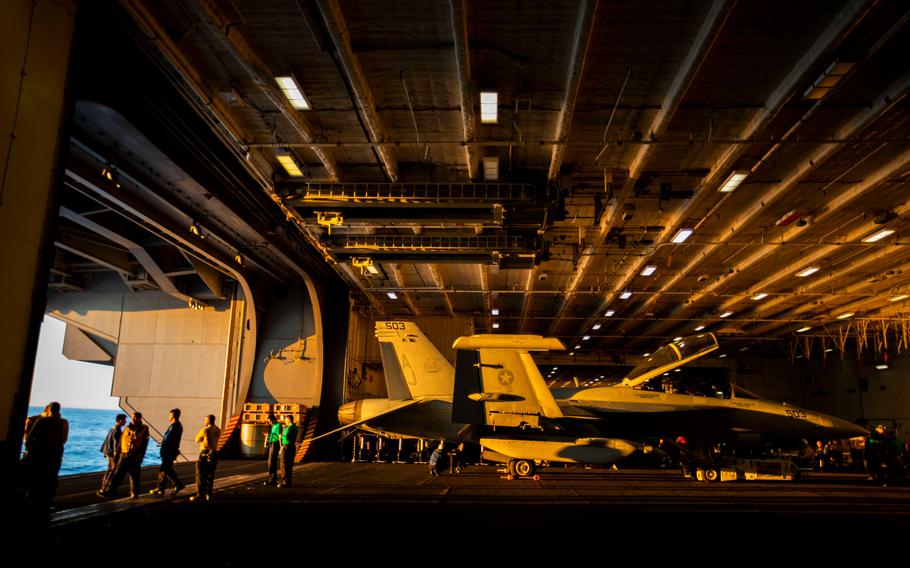 A plane sits in the hangar bay before being loaded onto the elevator to be brought up to the flight deck aboard the USS Gerald R. Ford on Thursday, Oct. 6, 2022.
