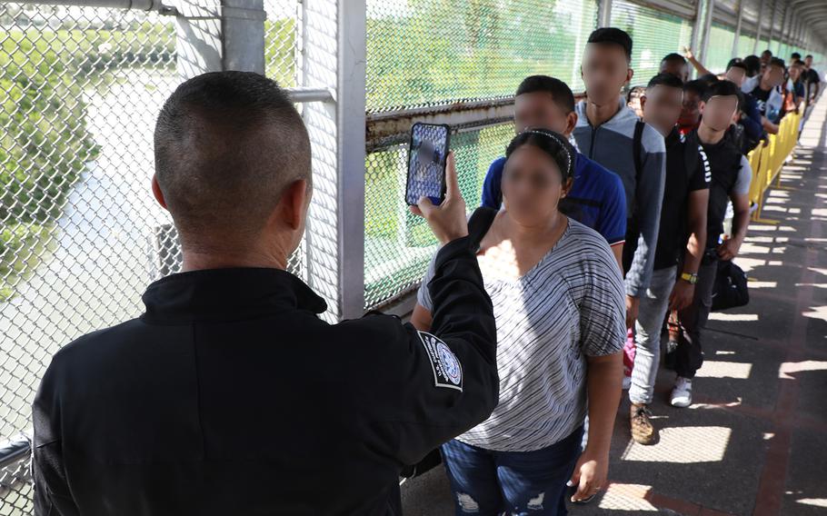 CBP personnel process and screen migrants using facial comparison software for possible entry into the U.S., on May 31, 2023 in Brownsville, Texas. 
