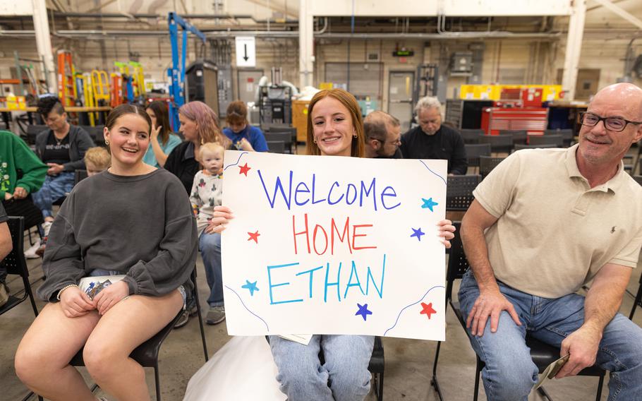 Family members of a Task Force Tomahawk soldier hold up a sign at the Task Force Tomahawk welcome home ceremony at Will Rogers Air National Guard Base in Oklahoma City, Feb. 24, 2024. 