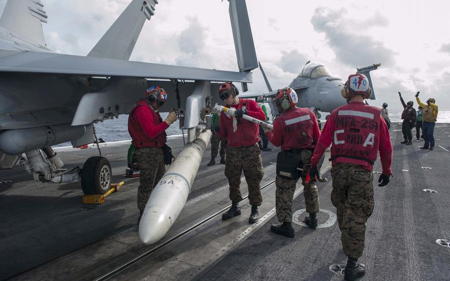U.S. Marines remove a high-speed, antiradiation missile (HARM) from an F/A-18C Hornet jet. HARMs are intended to bolster the Ukrainian military’s aerial-attack capabilities.