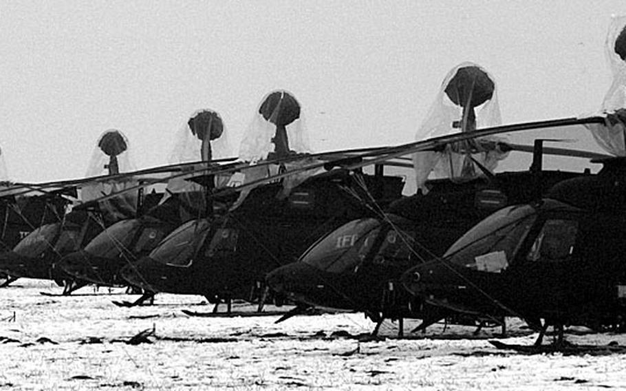 Taszar AB, Hungary, January, 1996: A fleet of attack helicopters rest on a snow covered field at Taszar AB.