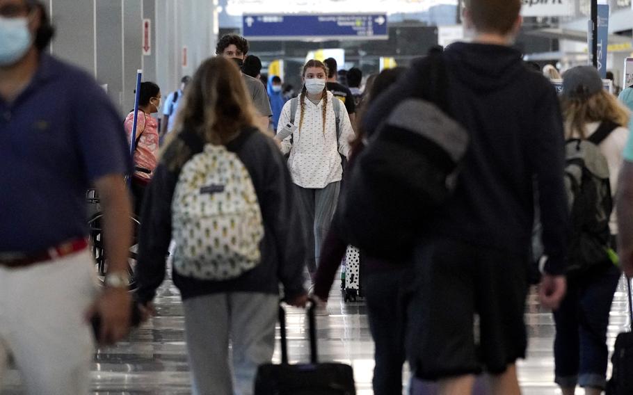 Travelers walk in Terminal 3 at at Chicago's O'Hare International Airport ahead of the Fourth of July weekend, Friday, July 2, 2021. 