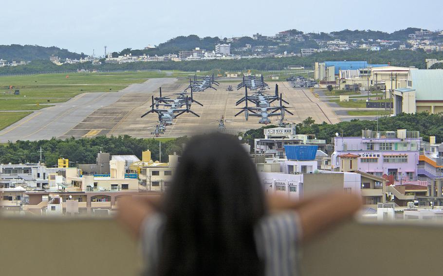 A child looks out at aircraft at Marine Corps Air Station Futenma, Okinawa, April 19, 2019.