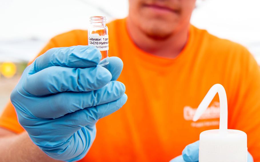 A Navy contractor tests a water sample from the Red Hill well in Honolulu in April 2022.