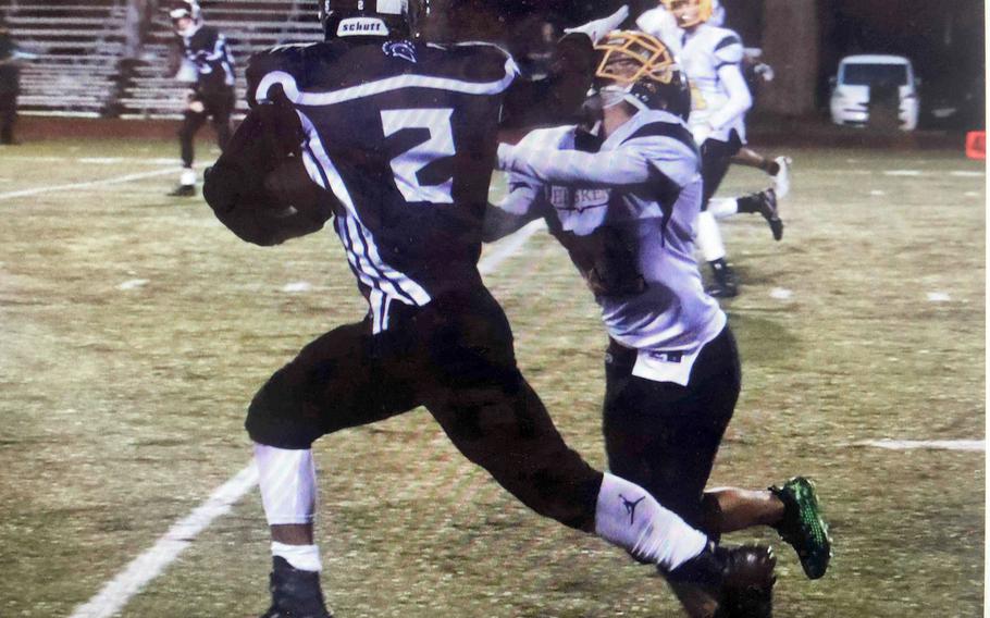 Zama receiver Keshawn McNeill stiff-arms Robert D. Edgren defender Hajime Reed en route to one of his three touchdowns.