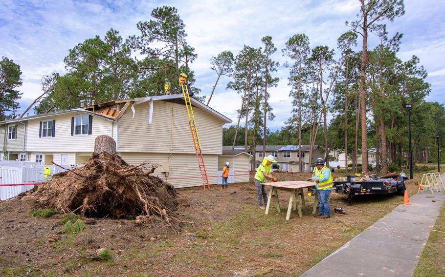 Roofs of damaged housing units are being repaired