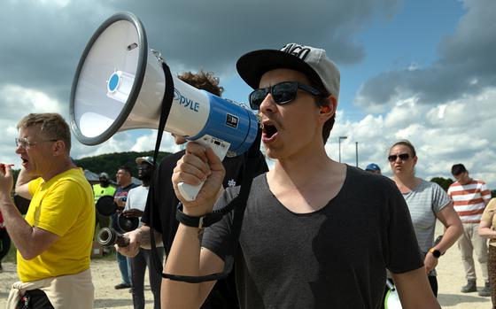 A protester yells into a megaphone.