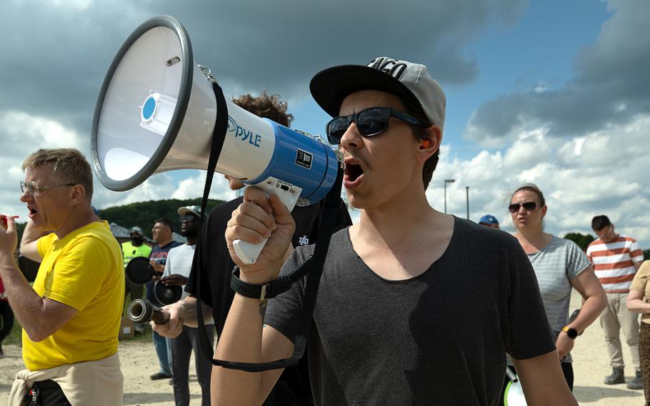 A protester yells into a megaphone.