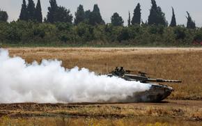 An Israeli tank manoeuvres near the Israel-Gaza border, amid the ongoing conflict between Israel and the Palestinian Islamist group Hamas, as seen from Israel, May 21, 2024. REUTERS/Amir Cohen