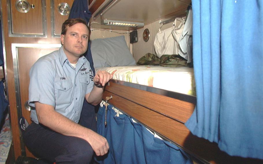 Navy Petty Officer 1st Class Erik Formo shows off his rack aboard USS Bremerton.  This is the only space Formo has to call his own, for sleeping, storage and relaxation.
