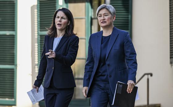 Germany's Foreign Minister Annalena Baerbock, left, and Australian Foreign Minister Penny Wong arrive for a news conference in Adelaide, Friday, May 3, 2024. (Michael Errey/Pool Photo via AP)