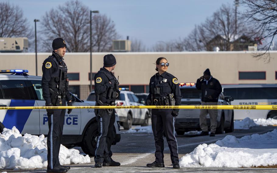Law enforcement officers stand outside a school housing an educational program called Starts Right Here that is affiliated with the Des Moines school district, following a shooting Monday, Jan. 23, 2023, in Des Moines, Iowa.