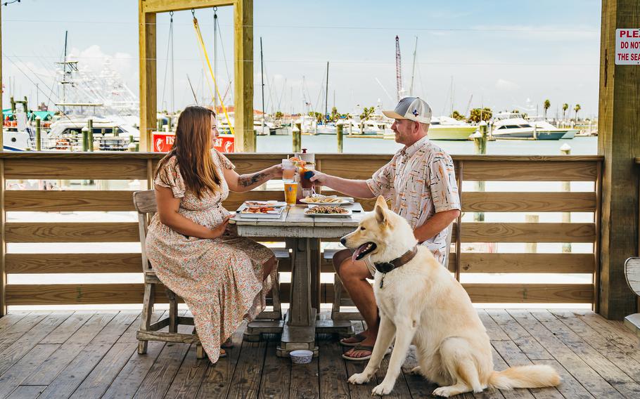 Guests, including the 4-footed variety, dine at Grumbles Seafood Co. in Port Aransas, Texas. 