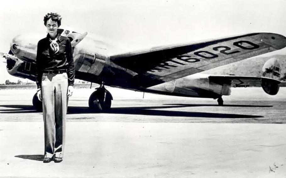 Amelia Earhart stands in front of the Lockheed Electra in which she disappeared in July 1937.