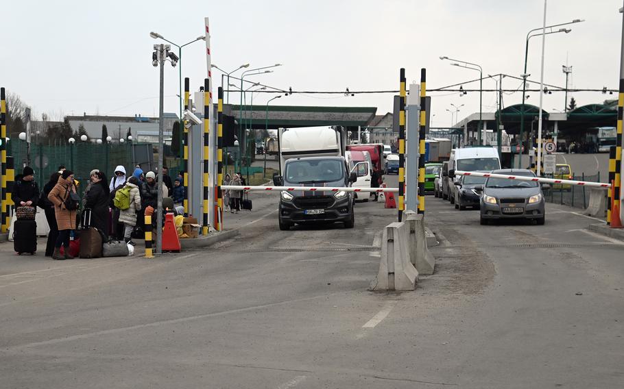 Refugees walking and in vehicles wait at the Ukrainian-Polish border at Medyka, before crossing into Poland, March 2, 2022.