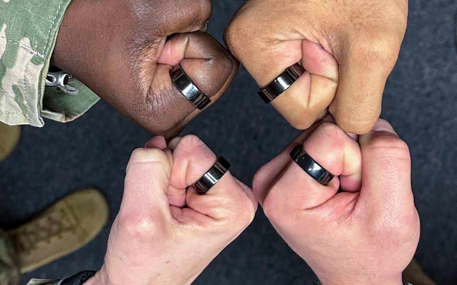 Air Force first sergeants at an event March 14, 2023, at Langley Air Force Base, Va., show off rings used with smartwatches to monitor their mental health and overall wellness.
