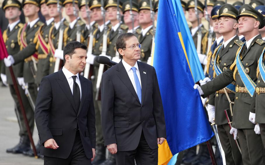 Ukrainian President Volodymyr Zelenskyy, left, and Israeli President Isaac Herzog review the honor guard during a welcome ceremony ahead of their meeting in Kyiv, Ukraine, Tuesday, Oct. 5, 2021.