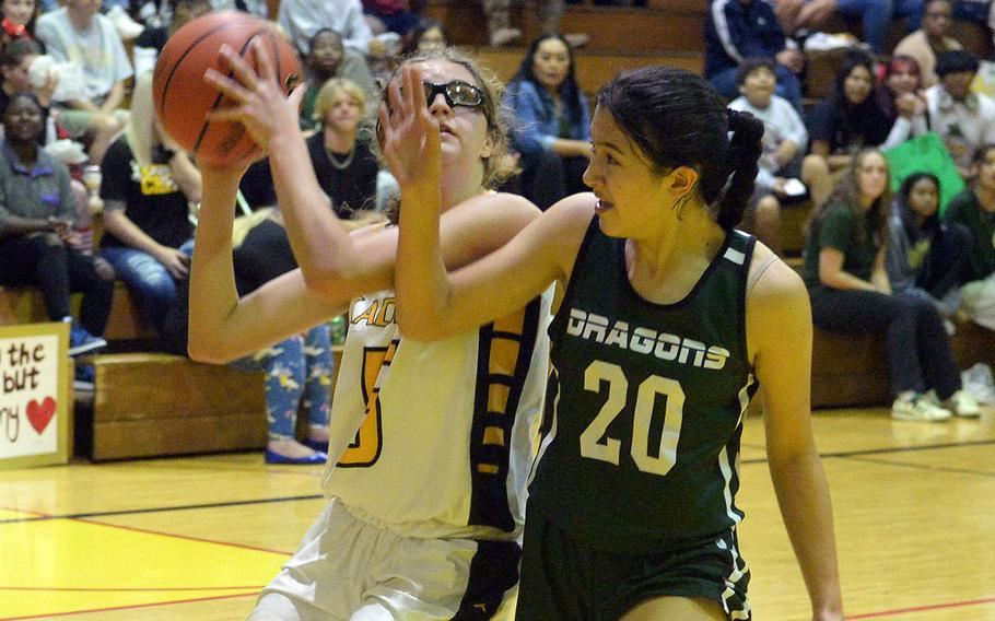 Kadena's Marina Sawyer drives to the basket against Kubasaki's Runa Holladay during Friday's DODEA-Okinawa girls basketball game. The Panthers won 44-40, leveling the season series at 1-1.