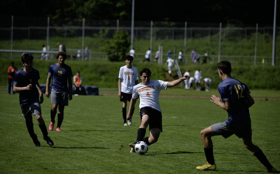 Logan Simmers of Spangdahlem attempts to pass the ball past Ansbach’s Lucas Rudy, right, and Ethan Serna during the 2024 DODEA European Soccer Division III Championships in Landstuhl, Germany, on May 20, 2024. Ansbach won the game 4-1.