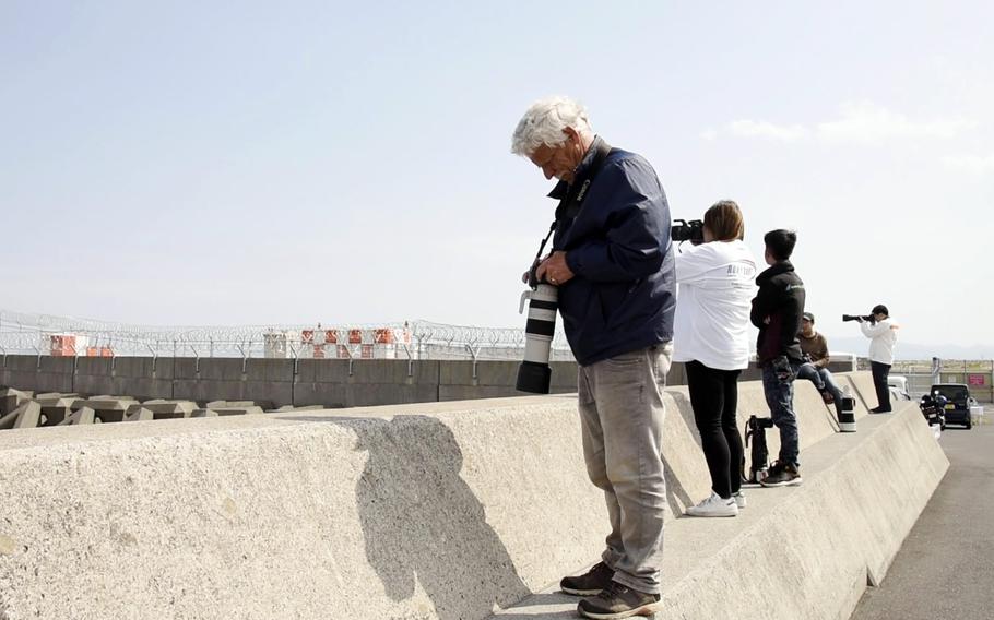 Hans Van Der Luit, a retired lawyer from Kleipettenlaan, Netherlands, reviews photos of military aircraft he took near Marine Corps Air Station Iwakuni, Japan, April 11, 2023.