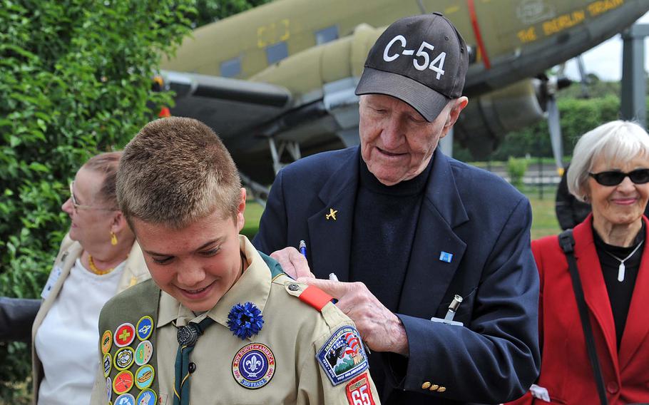 "Candy Bomber" Gail Halvorsen signs an autograph for Caleb Magowan of Wiesbaden Boy Scout Troop 65 at a ceremony May 15, 2011, in Frankfurt, Germany, commemorating the 62nd anniversary of the end of the Berlin Airlift. In June 1948, the Soviets established a land and water blockade of West Berlin. On June 26, 1948, the first relief flight left the airfield in Wiesbaden for Berlin. Halvorsen was legendary among Berlin children for dropping chocolate bars tied to parachutes during the airlift.