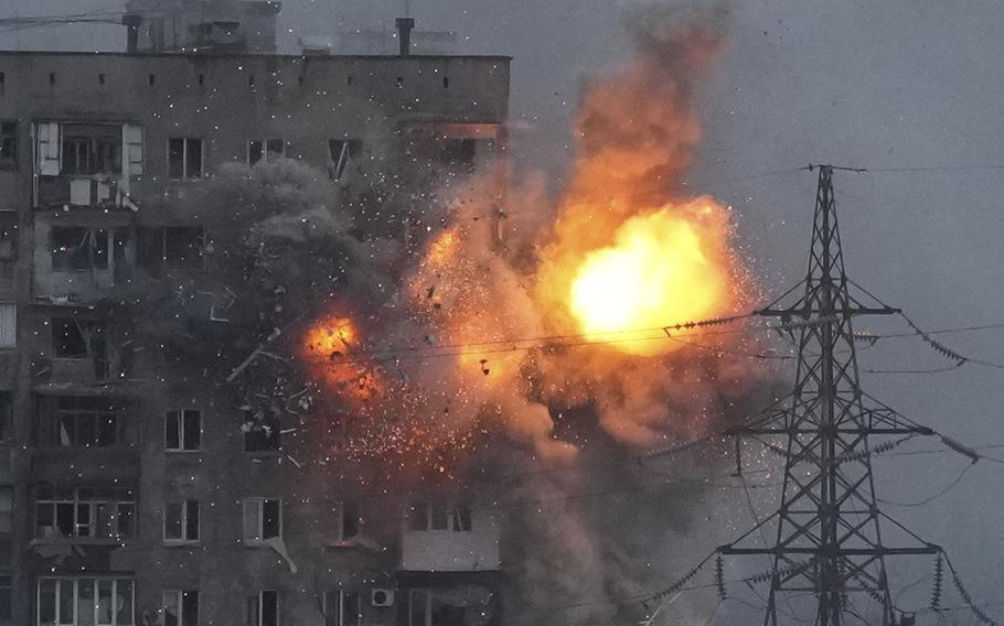 An explosion in an apartment building that came under fire from a Russian army tank in Mariupol, Ukraine, Friday, March 11, 2022.