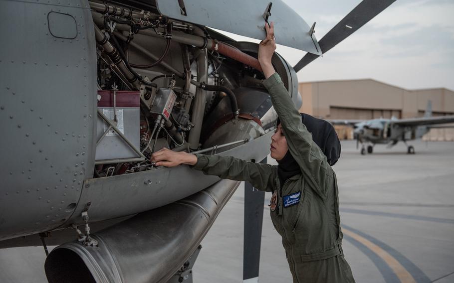 Afghan air force Capt. Safia Ferozi checks an engine on her C-208 in Kabul, Afghanistan, in 2017. Ferozi was evacuated after Afghanistan fell to the Taliban.