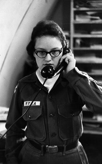 A woman talks on a landline phone