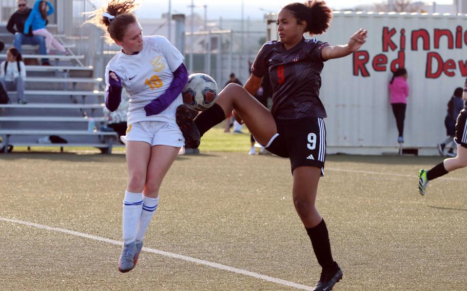 Yokota's Hailey Riddels and Nile C. Kinnick's Alyssa Staples try to settle the ball during Wednesday's DODEA-Japan girls soccer match. The Red Devils won 4-1.