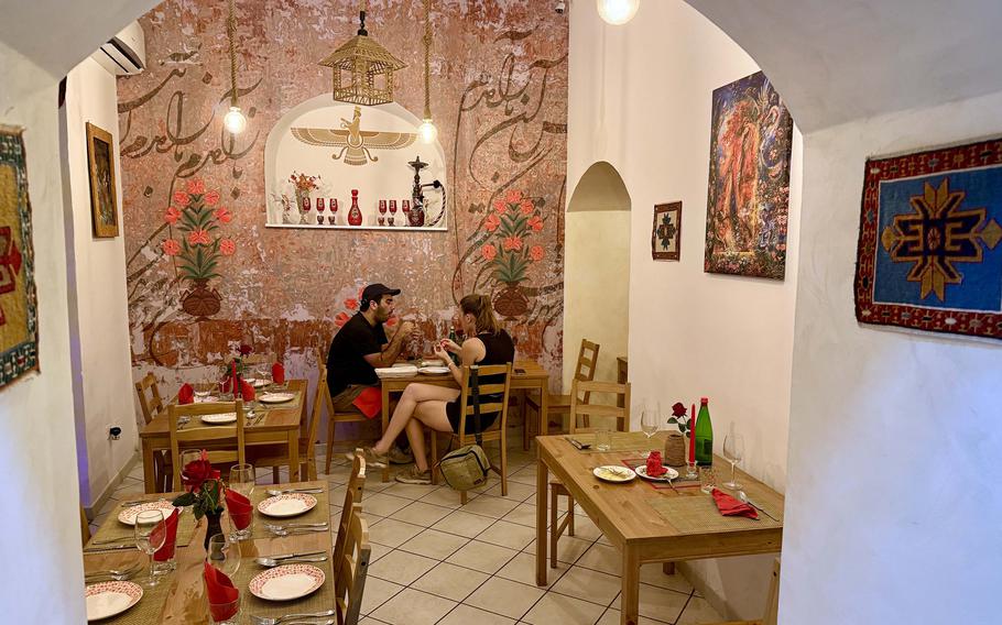 The interior of Soraya Persian Taberna and Tea House is decorated with Persian art.