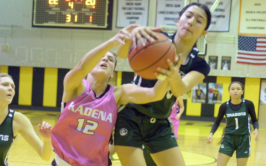 Kadena's Katelyn Wetherington and Kubasaki's Runa Holladay come down with a rebound during Friday's Okinawa girls basketball game. The Dragons won 28-24, giving them a 3-1 season-series edge over the Panthers, their first in 20 seasons.
