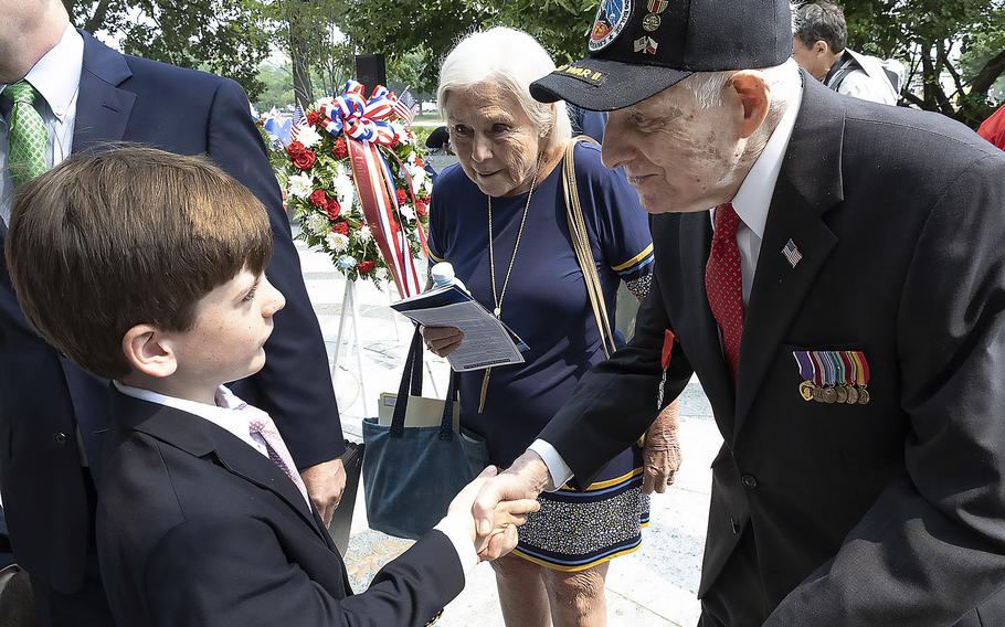 Following a ceremony at the National World War II Memorial in Washington on Tuesday, June 6, 2023, veteran Lincoln Harner meets Thatcher Roosevelt, the great-great grandson of the man who was commander in chief when Harner and thousands of other Americans took part in the invasion of Normandy in June 1944. Thatcher's father, Elliott Roosevelt III, was the keynote speaker at a D-Day anniversary ceremony during which a monument bearing President Franklin D. Roosevelt's prayer to the nation as the invasion unfolded was dedicated.