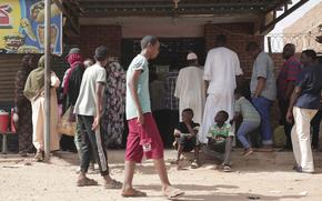 People line up in front of a bakery during a cease-fire in Khartoum, Sudan, Saturday, May 27, 2023. Saudi Arabia and the United States say the warring parties in Sudan are adhering better to a week-long cease-fire after days of fighting. (AP Photo/Marwan Ali)