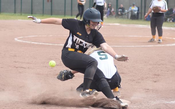Vicenza's Hannah Findlay slides across third base while Alconbury's Miranda Cowen tries to grab the ball Friday, May 23, 2025, at the DODEA-Europe Division I softball championships at Kaiserslautern, Germany.