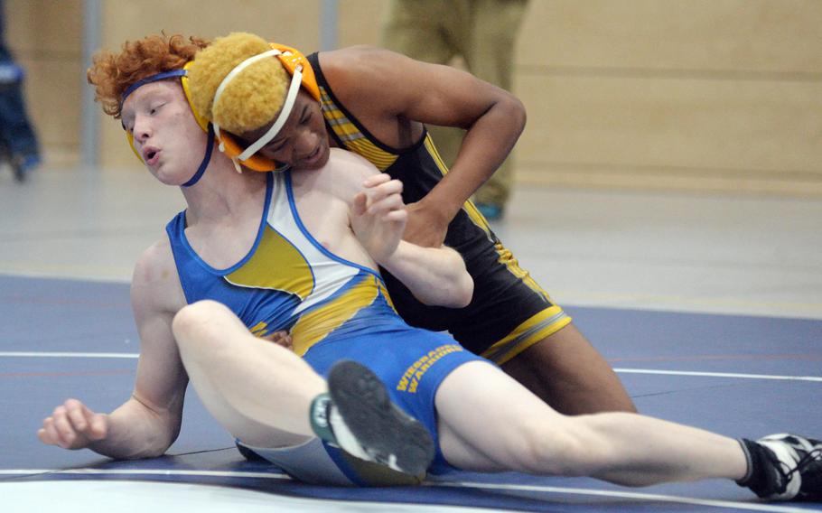 Wiesbaden’s Griffith Bessent, left, struggles against Stuttgart’s Valentino Antoine in a 144-pound match at the high school 2022 Wrestling Tournament in Ramstein.