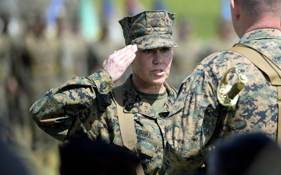 Marine Sgt. Maj. Joy Kitashima salutes Lt. Gen. James Bierman, commander of the III Marine Expeditionary Force, at Camp Courtney, Okinawa, March 7, 2023.