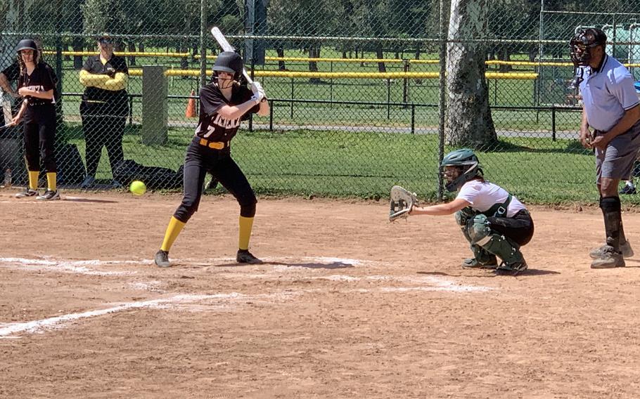 Vicenza's Elizabeth Saari takes a turn at bat as Naples catcher Rebecca Lee waits for the ball Saturday, April 30, 2022 at Carney Park in Naples, Italy. The Wildcats won 12-1.
