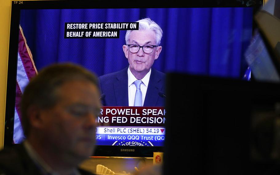 Federal Reserve Chairman Jerome Powell news conference is displayed on televisions while traders work on the floor at the New York Stock Exchange in New York, Wednesday, June 15, 2022.