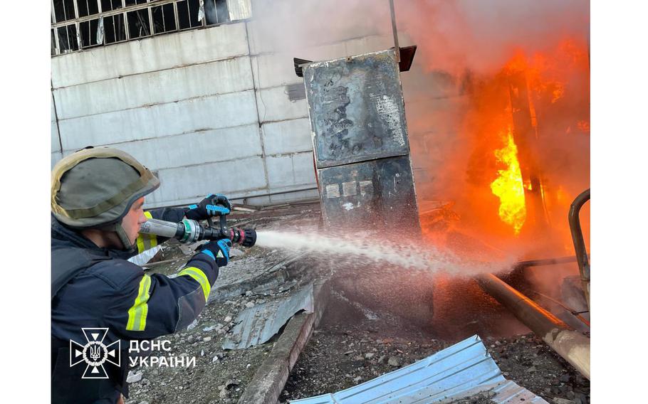 A firefighter works at a compound of power infrastructure facilities, which was hit by Russian missile and drone strikes an undisclosed location in Ukraine, on April 11, 2024. 